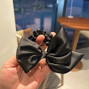 Elegant black satin bow hair tie with sparkling rhinestone accents for women ponytail