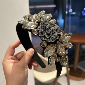 Detail of luxury padded headband featuring crystal rhinestones and a silver rose motif
