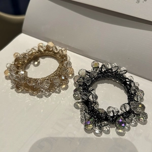 Elegant crystal beaded hair ties in champagne gold and iridescent black for stylish ponytails