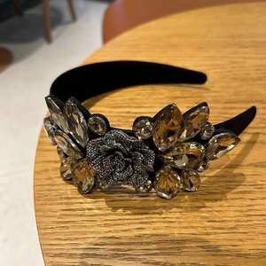Detail of luxury baroque headband with champagne crystals and dark grey rose flower