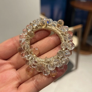 Close-up of premium champagne crystal beads on high-elasticity braided hair ring