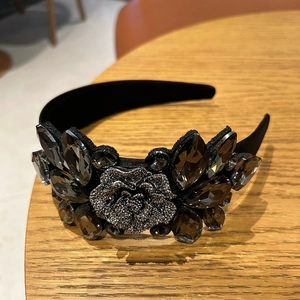 Macro shot of luxury black velvet headband featuring grey crystals and a 3D rose flower detail