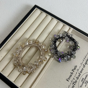 Detailed macro shot of crystal beaded elastic hair ties in champagne and iridescent shades