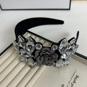 Luxury Baroque headband with crystal flowers and black fabric on a jewelry display tray