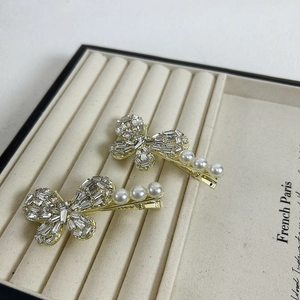 Elegant gold bow hair clips with rectangle crystals and white pearls for women