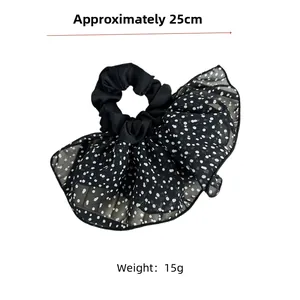 Detail of black polka dot mesh hair scrunchie with 25cm size and 15g weight measurements