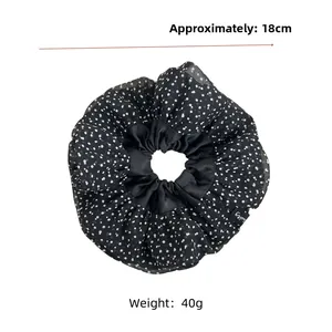 Detail shot of 18cm retro polka dot organza scrunchie with 40g lightweight design