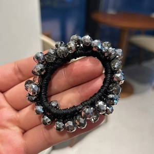 Detail of silver faceted crystal beads on high elasticity black hair tie strap