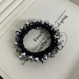 Elegant beaded hair tie with silver faceted crystals on a black elastic cord for women