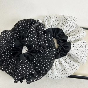 Detailed view of polka dot pattern on soft chiffon fabric oversized hair scrunchies