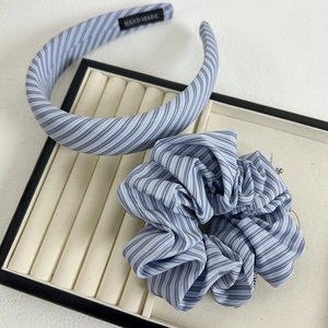 Detail of blue and white striped headband and scrunchie set with handmade fabric texture