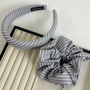 Detail view of handmade grey and white striped cotton headband and matching scrunchie set