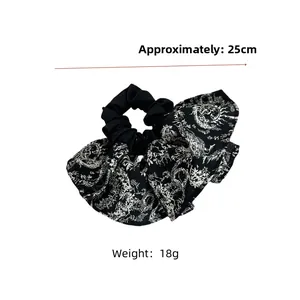 Detail view of monochrome floral pattern scrunchie with 25cm width and 18g weight