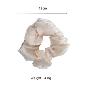 Detail of 12cm white lace hollow scrunchie with light beige organza fabric texture
