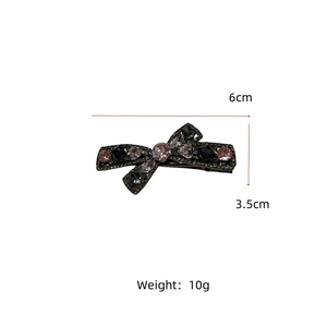 Detailed view of rhinestone bow hair clip showing 6cm x 3.5cm dimensions and fine gems