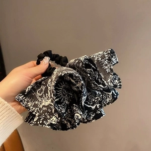 Detail of vintage French Toile de Jouy print on an oversized fabric hair scrunchie