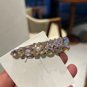 Elegant silver metal hair clip with purple rhinestones and central white pearl accent