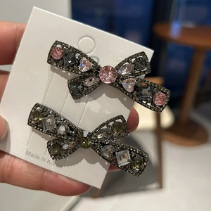 Sparkling rhinestone bow hair clips in two colors on a white display card