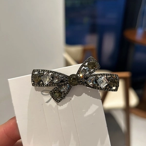 Sparkling rhinestone bow hair clip with dark grey crystals for elegant hair styling