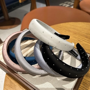 Detail of satin padded headbands with silver rhinestones and handmade woven labels