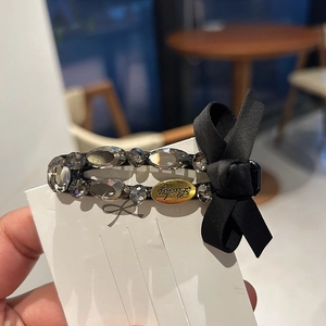 Elegant black ribbon bow hair clip with luxury rhinestones and gold Lucky tag