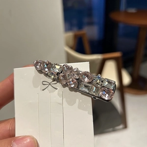 Luxury rhinestone duckbill hair clip with pink crystals on a white display card