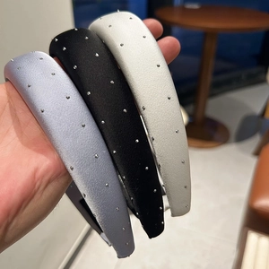 Detailed view of satin padded headbands with sparkling rhinestones in three elegant colors