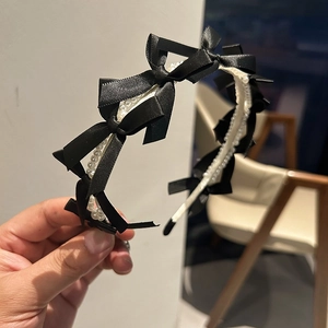 Elegant black ribbon bow headband with white pearls for women's hair styling