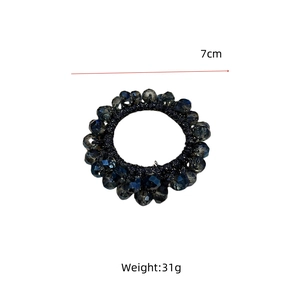 Detailed view of a navy blue crystal bead hair tie, 7cm diameter and 31g weight
