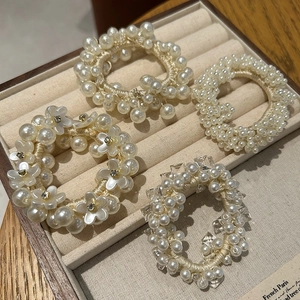 Detail view of 4pcs pearl hair scrunchie set with camellia and beads in a jewelry box