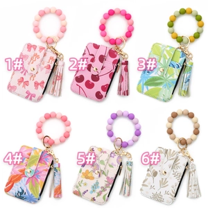 Close-up of floral PU leather card holder sets with silicone bead wristlets and tassels