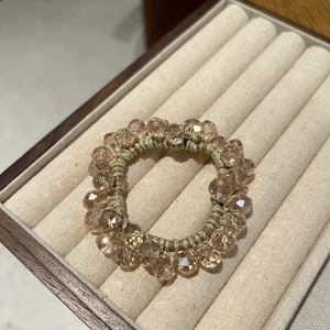 Elegant champagne crystal beaded elastic hair tie displayed in a jewelry box