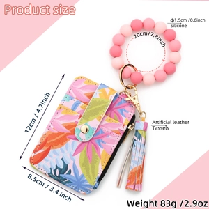 Detailed view of floral faux leather card holder with silicone bead wristlet and size specs