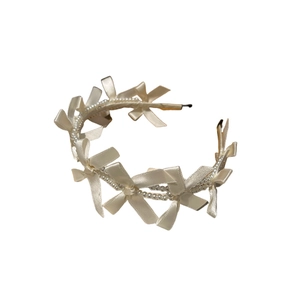 Elegant cream white headband with satin bows and pearl chains on a flexible metal frame