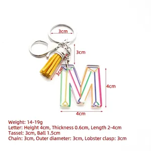 Personalized letter M acrylic keychain with yellow tassel and colorful geometric patterns