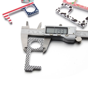 Detailed measurement of a floral acrylic door opener tool using a digital caliper