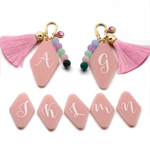 Pink acrylic geometric initial keychain with tassel and colorful beads gold hardware