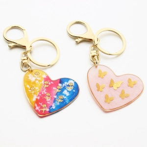 Artistic resin heart keychains with gold rose and butterfly foil in vivid colors