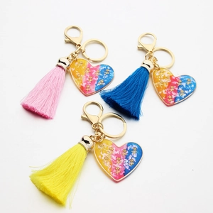 Creative heart resin keychains with gold roses and colorful tassels in pink blue and yellow