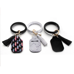 Wristlet keychain with 30ml sanitizer holder, tassel charm, and marble feather patterns