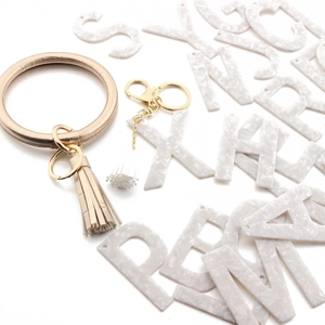 Detail of champagne gold PU leather leopard bangle with stylish matching tassel accessory