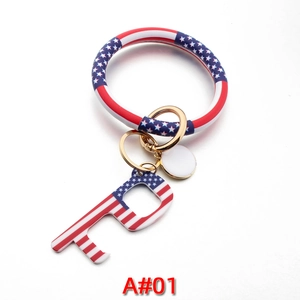 Detail view of American flag pattern leather wristlet with golden keyring and P-shaped opener