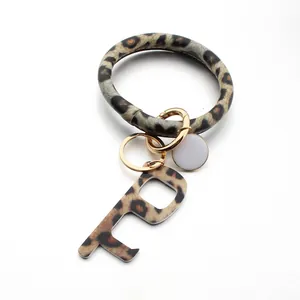 Leopard print leather bracelet keychain with gold lobster clasp and no-touch door opener tool