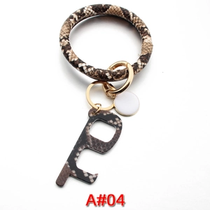 Macro detail of snakeskin texture PU leather bracelet and contactless door opener keyring