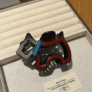 Detail einer Haarspange in Form eines Scottish Terriers aus Acetat in Rot und Schwarz
