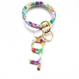 Detail showing marble textured wristlet bangle keychain with golden metal ring and hook