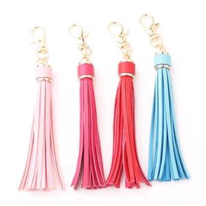 Detail of colorful PU leather tassel keychains with golden lobster clasps in four shades