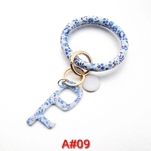 Blue and white floral PU leather wristlet with acrylic touchless door opener tool