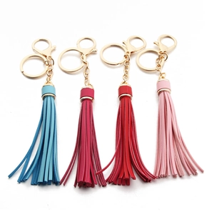 Detailed view of colorful leather tassel keychains with golden lobster clasps and rings