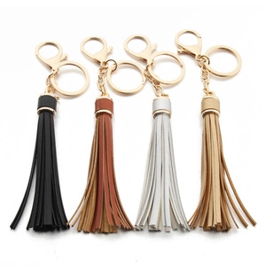Detail view of colorful PU leather tassels with gold caps and metal keychains
